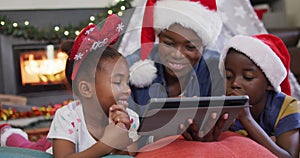 Happy african american mother with children using tablet