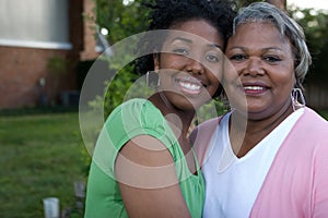 Happy African American mother and her daugher.