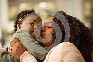 Happy African American mother and her daugher.