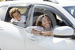 Happy african american mother and son looking from car windows