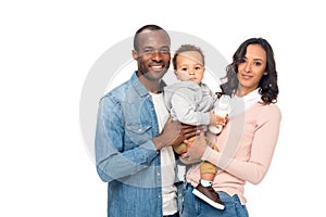 happy african american parents carrying cute little son and smiling at camera