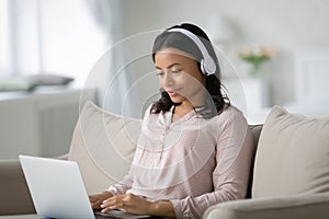 Happy African American student wearing wireless headphones