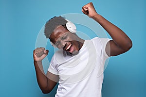 Happy african american teen listening to music with headphones