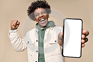 Happy African American winner showing big mock up mobile phone screen. photo