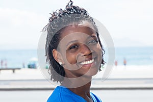 Happy african american woman in a blue shirt