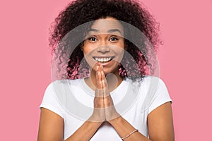 Happy African American woman joining hands with excitement photo