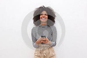 Happy african american woman holding smart phone