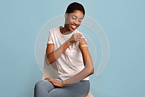 Happy African American Woman Looking At Her Shoulder After Coronavirus Vaccine Injection