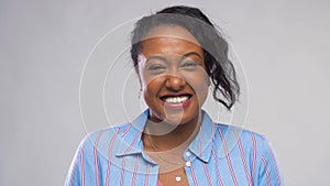 Happy african american woman over grey background