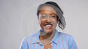 Happy African American woman over grey background