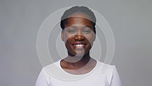 Happy african american woman over grey background