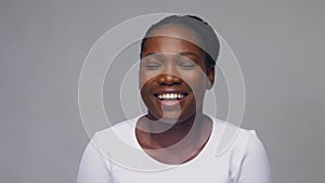 Happy african american woman over grey background