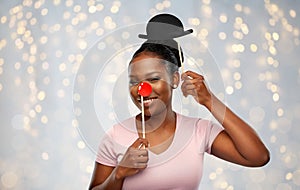 Happy african american woman with red clown nose photo