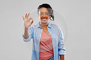 Happy african american woman showing ok hand sign