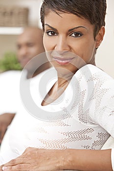 Happy African American Woman Sitting At Home