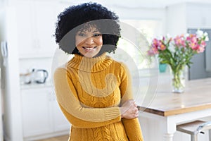 Happy african american woman standing holding hand at home, copy space