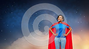 Happy african american woman in superhero red cape