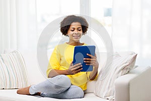 Happy african american woman with tablet pc