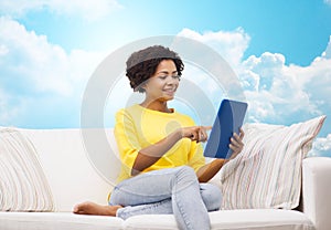 Happy african american woman with tablet pc