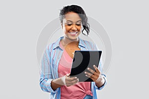 Happy african american woman using tablet pc