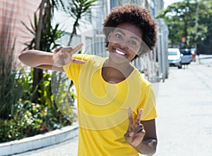 Happy african american woman in a yellow shirt