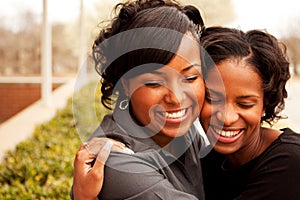 Happy African American women laughing and smiling.