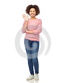 Happy african american young woman waving hand