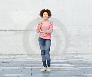 Happy african american young woman waving hand