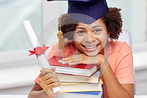 Happy african bachelor girl with books and diploma