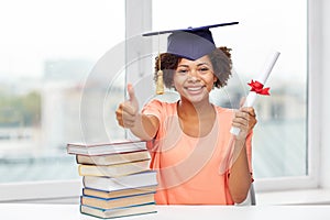 Happy african bachelor girl with books and diploma