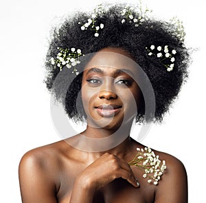 Happy African Beauty Model Face Portrait with White Flower in Afro Hair Style. Woman with Black Hair enjoying Body Skin Care Spa