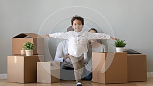 Happy african boy running in new apartment on moving day