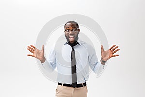 Happy african businessman wearing a corporate grey shirt and black tie punching the air with his fists arms in air