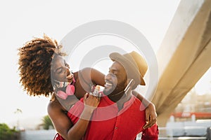 Happy African couple piggyback outdoor during corona virus pandemic