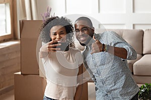 Happy african couple takes selfie photo carton boxes on background