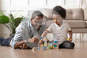 Happy african dad and child son building constructor from blocks