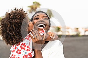 Happy African family on the beach during summer holidays - Afro American people having fun on vacation time