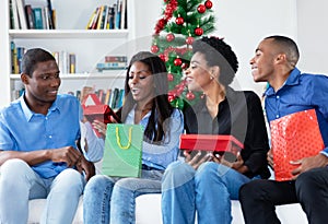 Happy african african family celebrating christmas with gifts and presents