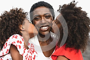 Happy African family having fun on the beach during summer holidays - Portrait of Afro people enjoying vacation days