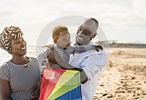 Happy African family having fun on the beach during summer vacation