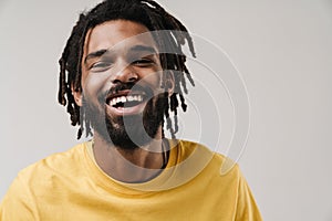 Happy african guy posing isolated over grey wall background