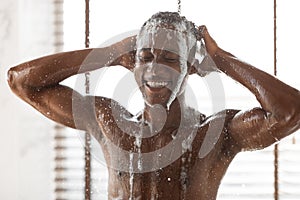 Happy African Guy Washing Head Taking Shower At Home