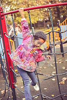 Happy African liitle girl in playground.