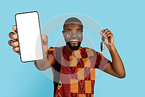 Happy African Man Holding Blank Smartphone And Showing Car Key At Camera