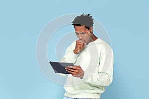 Happy african man looking at tablet