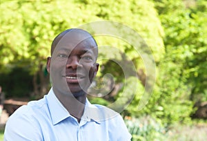 Happy african man in park looking at camera