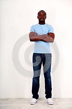 Happy african man standing with arms folded