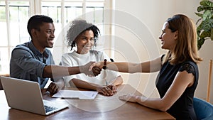 Happy African married couple shake hands to mortgage insurance broker