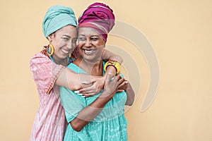 Happy african mother and daughter hugging each others - Focus on senior woman