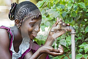 Happy African Schoolgirl Enjoying Clean Water from a Tap in Bamako, Mali